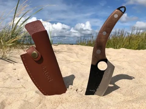 Satori knife with leather sheath on beach